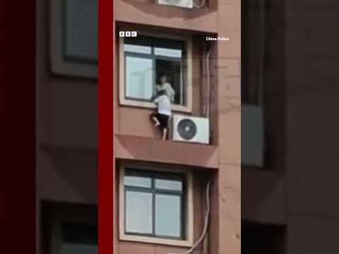 Child plays on high-rise window ledge in China. #Shorts #China #BBCNews